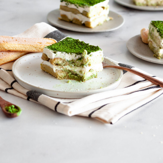 a bitten slice of eggless matcha tiramisu