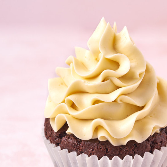 ermine buttercream topped on a chocolate cupcake