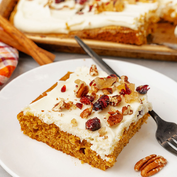 A slice of pumpkin cake on a white plate.