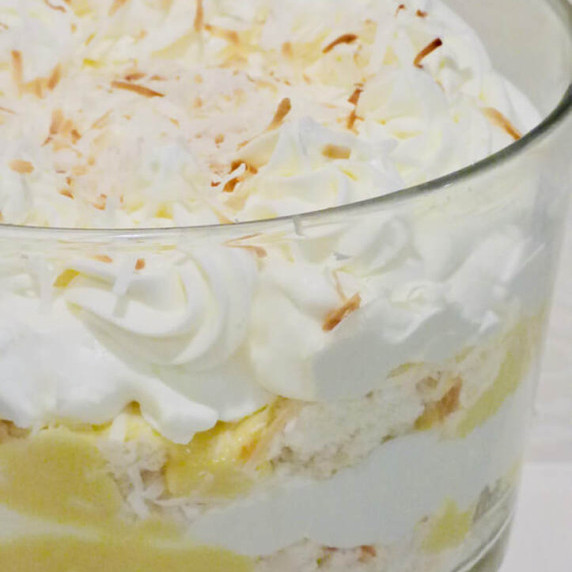 Coconut Cream Pie Trifle dessert on a white tablecloth.  