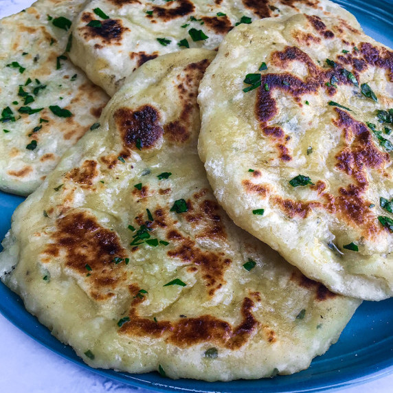 A plate with pan fried flatbread made with Greek yogurt.
