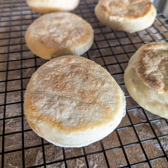 English muffins on a wire rack.