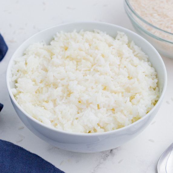 How to Cook Basmati Rice RECIPE in a white bowl on the countertop.