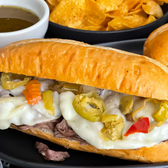 Italian beef sandwich on a dark plate.