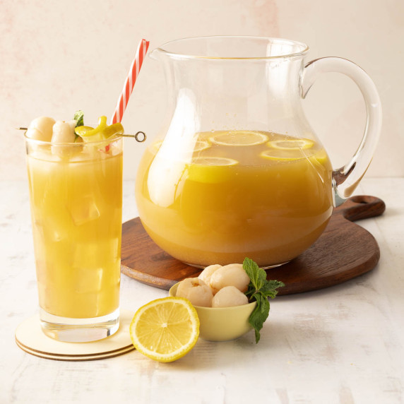 A pitcher of iced tea with lemons and lychees, 