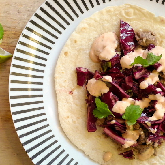 Japanes flavored tacos served in taco bread with red cabbage salad, lime, coriander and chili paste