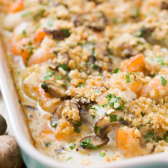 Scallops, shrimp, fish and mushrooms in a cream sauce with a cracker topping.