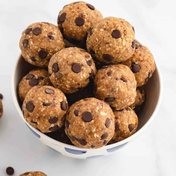 Oatmeal cookie dough bites with chocolate chips in a white bowl.