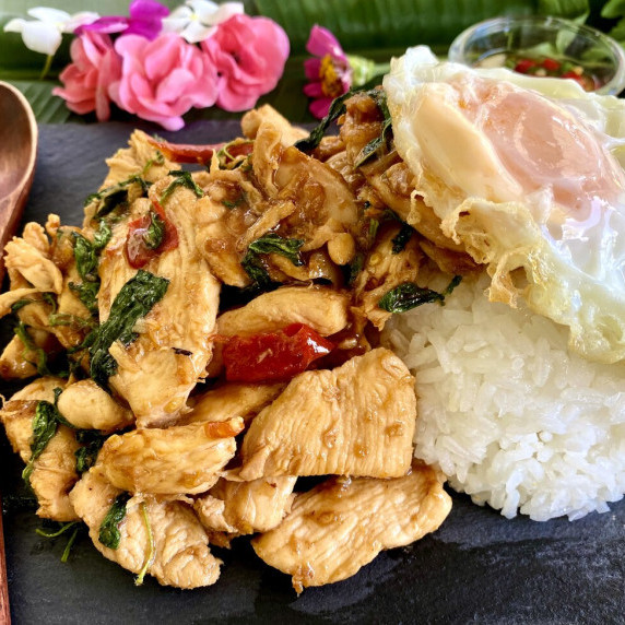 Pad krapow gai, Thai basil chicken stir-fry, with a portion of rice and a fried egg.