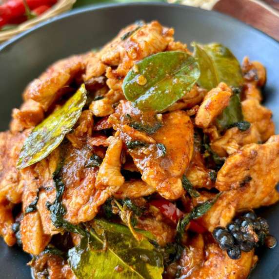 Pad ped gai, Thai red curry chicken stir-fry, with kaffir lime leaves, fresh peppercorns, and chili.