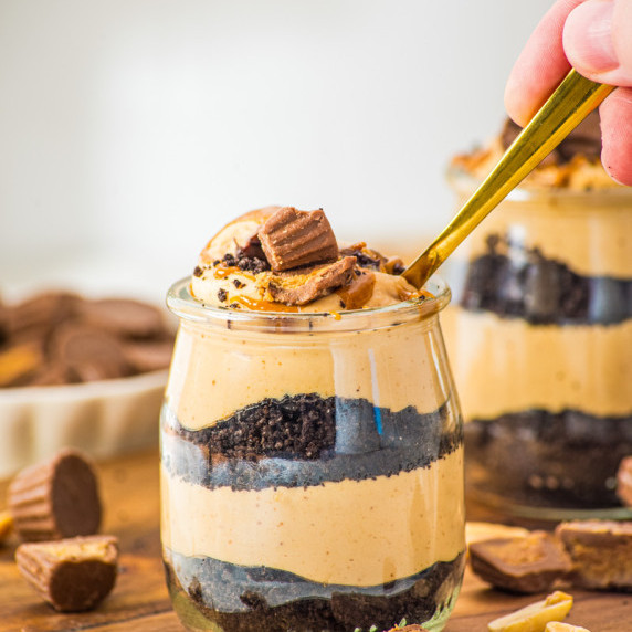 a jar filled with layers of Oreos ad peanut butter mousse. 