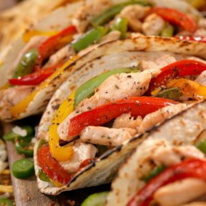 Fajitas with meat and veggies in tortillas