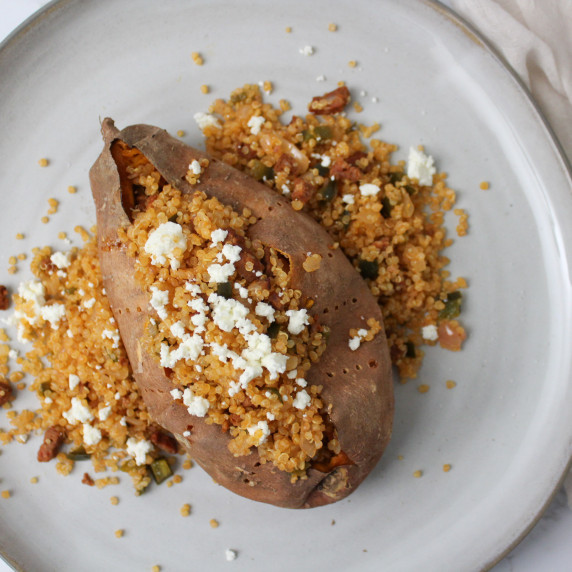 A sweet potato stuffed with quinoa, chorizo and goat cheese.