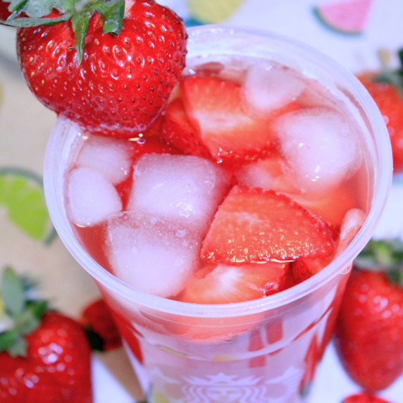 strawberry drink on a bright tablecloth with strawberries.  