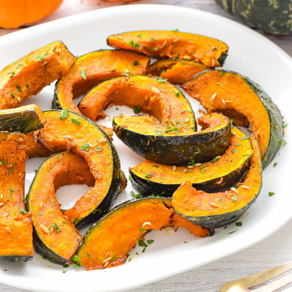 roasted kabocha squash wedges on a platter.