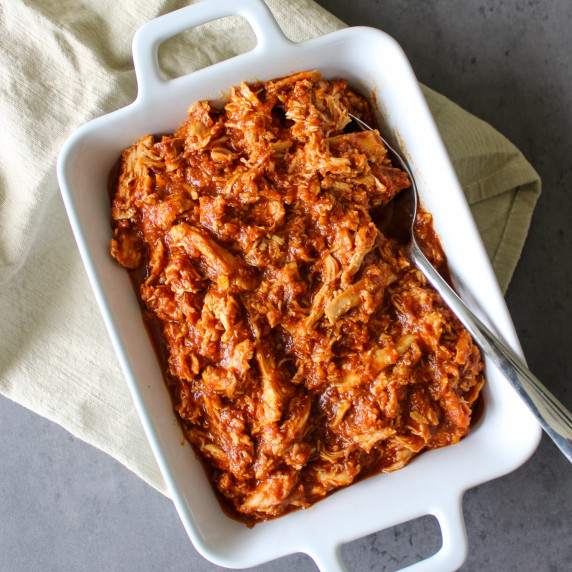 A serving dish of shredded spicy chipotle chicken