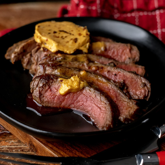 slices of steak with butter on top