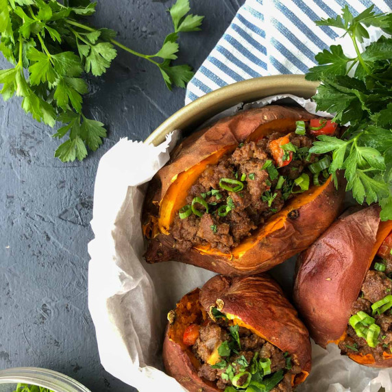 overhead shot of sloppy Joe stuffed sweet potatoes with parsley and green onions