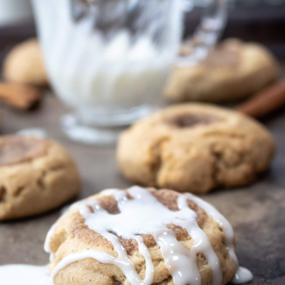 brown sugar thumbprint cookies on a baking sheet with icing