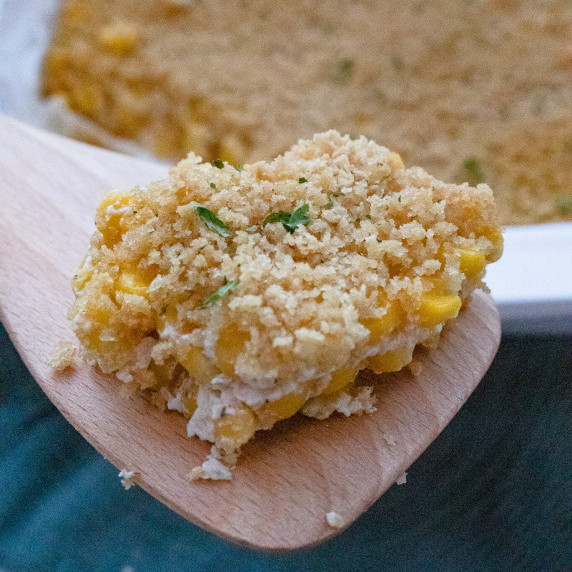 Creamed corn casserole on a spoon