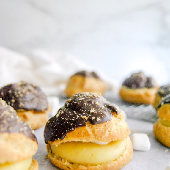 smores cream puffs on gray background with mini marshmallowas