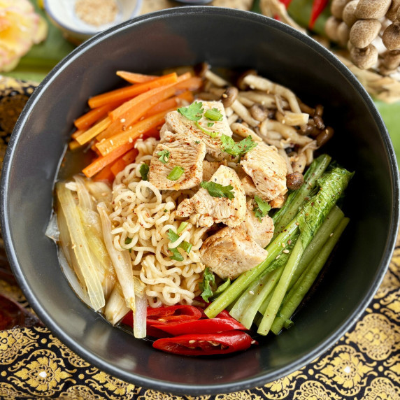 Close-up of spicy chicken ramen soup.