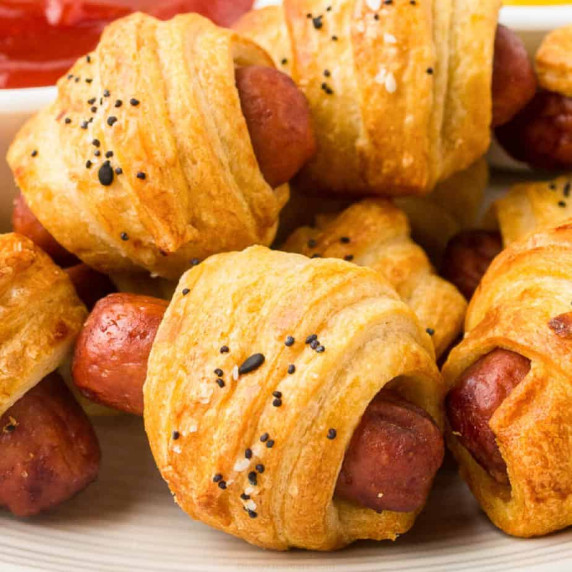 Close up of stacked pigs in a blanket up close from the side.
