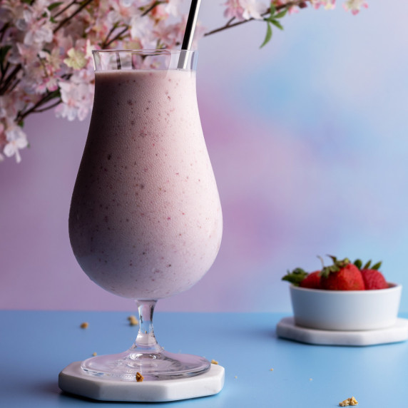 Strawberry banana milkshake in a tall glass