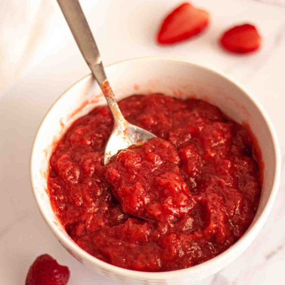 A bowl of strawberry filling for cakes.