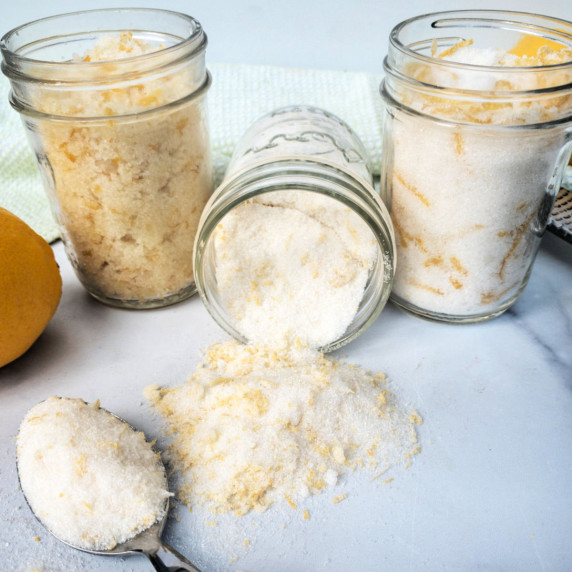 Three mason jars filled with different types of lemon sugar.