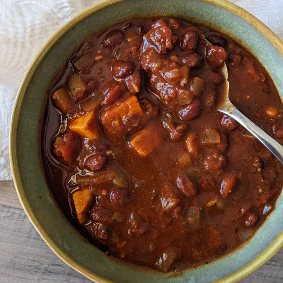 A bowl of chili made with sweet potatoes and black beans