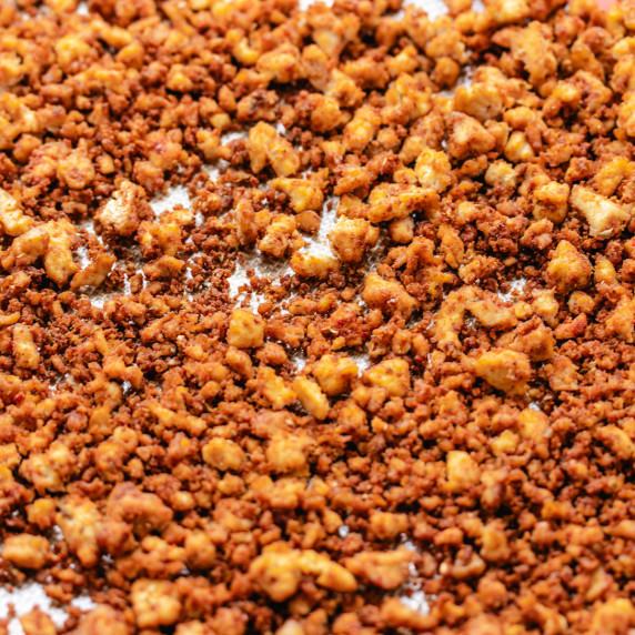 Cooked tofu meat crumbles on a silicone mat.