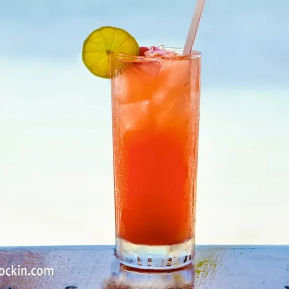 Tropical Bay Breeze drink in a glass, garnished with a lime slice.