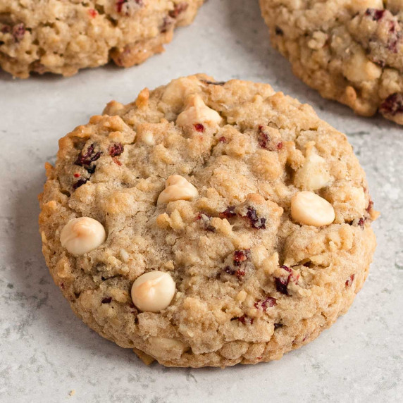 White chocolate cranberry oat cookies arranged on a light surface.