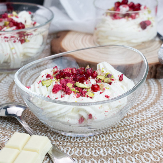 white chocolate mousse with pomegranate and pistachio on top