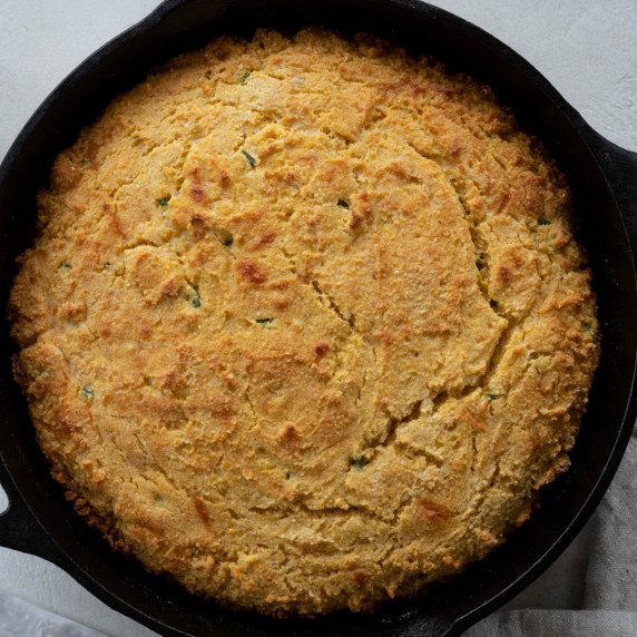 A whole wheat cornbread in a cast iron skillet